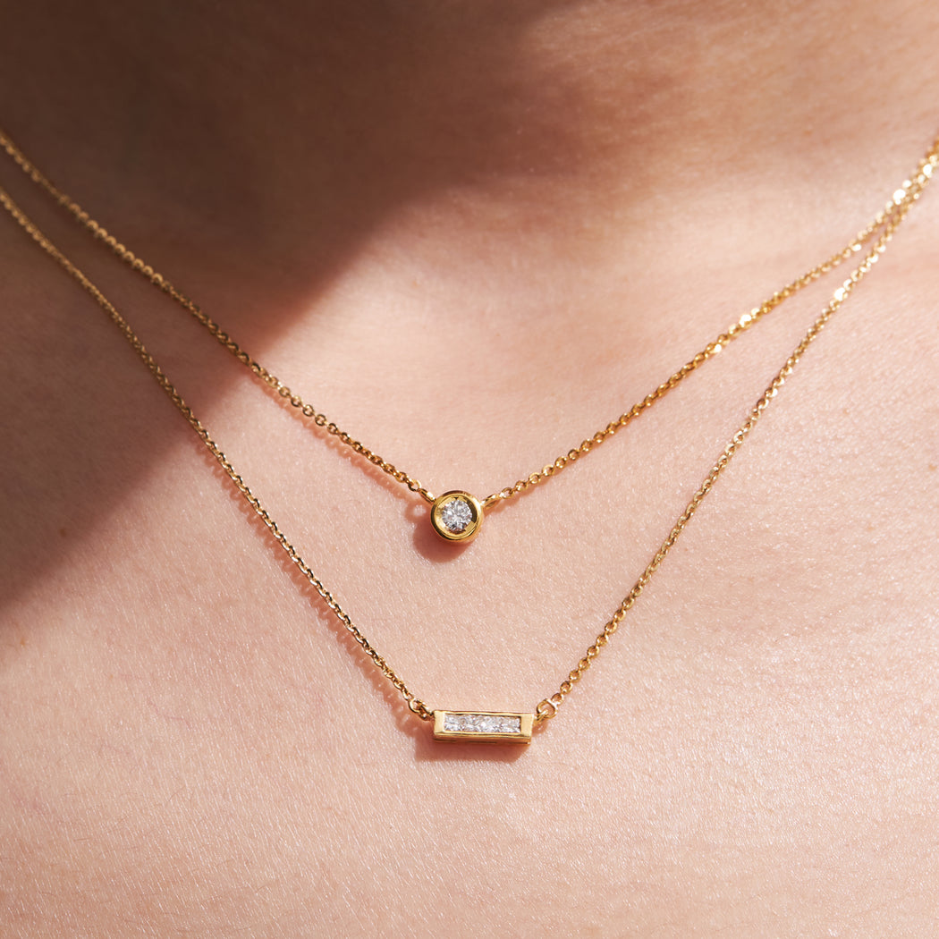 diamond bar paired with solitaire pendent necklace, 9k gold and diamonds